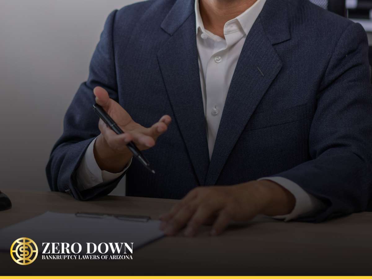 Bankruptcy lawyer discussing paperwork during a client consultation on financial matters